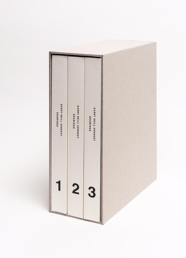 Three thick cream coloured books are held in a cardboard book set. Each spine reads GARRY NEILL KENNEDY DRAWINGS in black sans serif font and each book is numbered 1 2 or 3 at the bottom. 