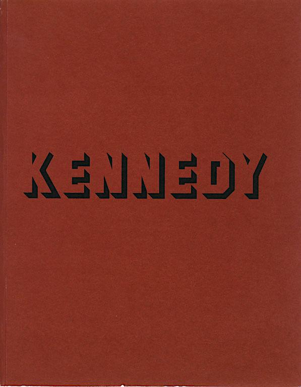 The name KENNEDY is written in black superstar shadow font over a red iron oxide background