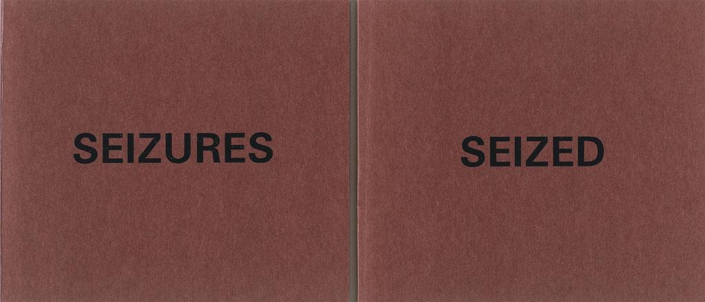  Two square burgundy books laying side-by-side. The one on top reads SEIZURES, the one below, SEIZED.