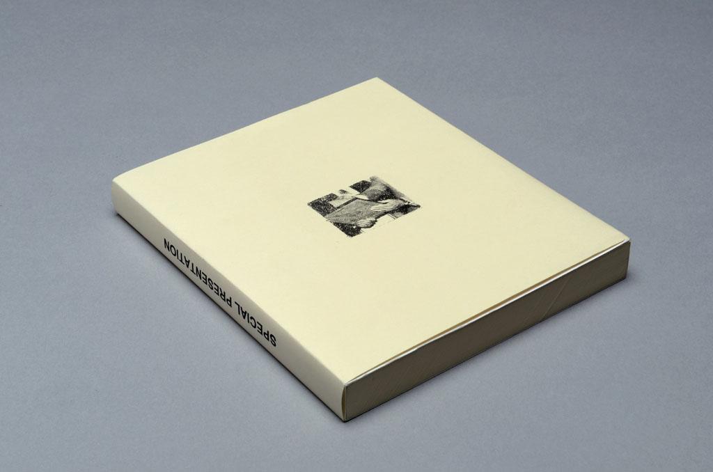 A cream-coloured book laying on a grey backdrop. The spine of the book reads "Special Presentation", and the cover has a small image of a person handing a plaque over to another person.
